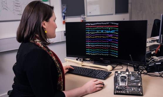 A woman looking at statistics on a computer screen