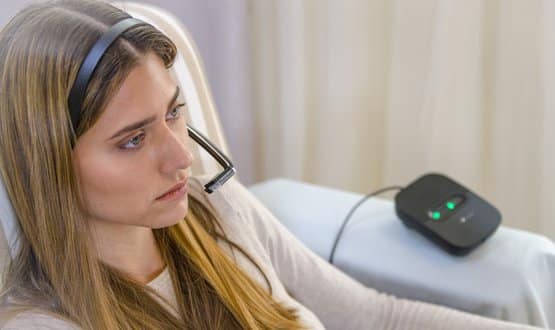 A woman wearing the eye-controlled device for locked-in individuals