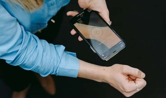 A woman using the SkinVision app to scan a mole on her arm