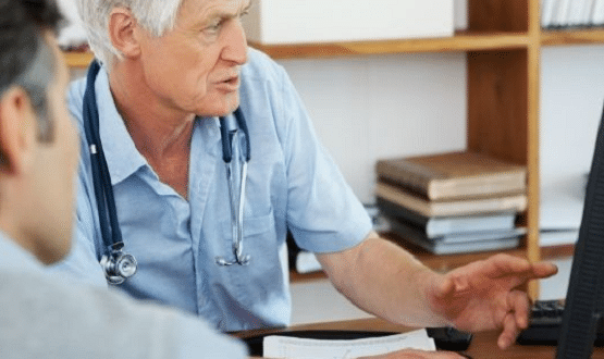 Too doctors looking at a computer screen