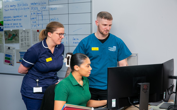 Three staff members looking at a computer screen at SUSSEX COMMUNITY NHS FOUNDATION TRUST